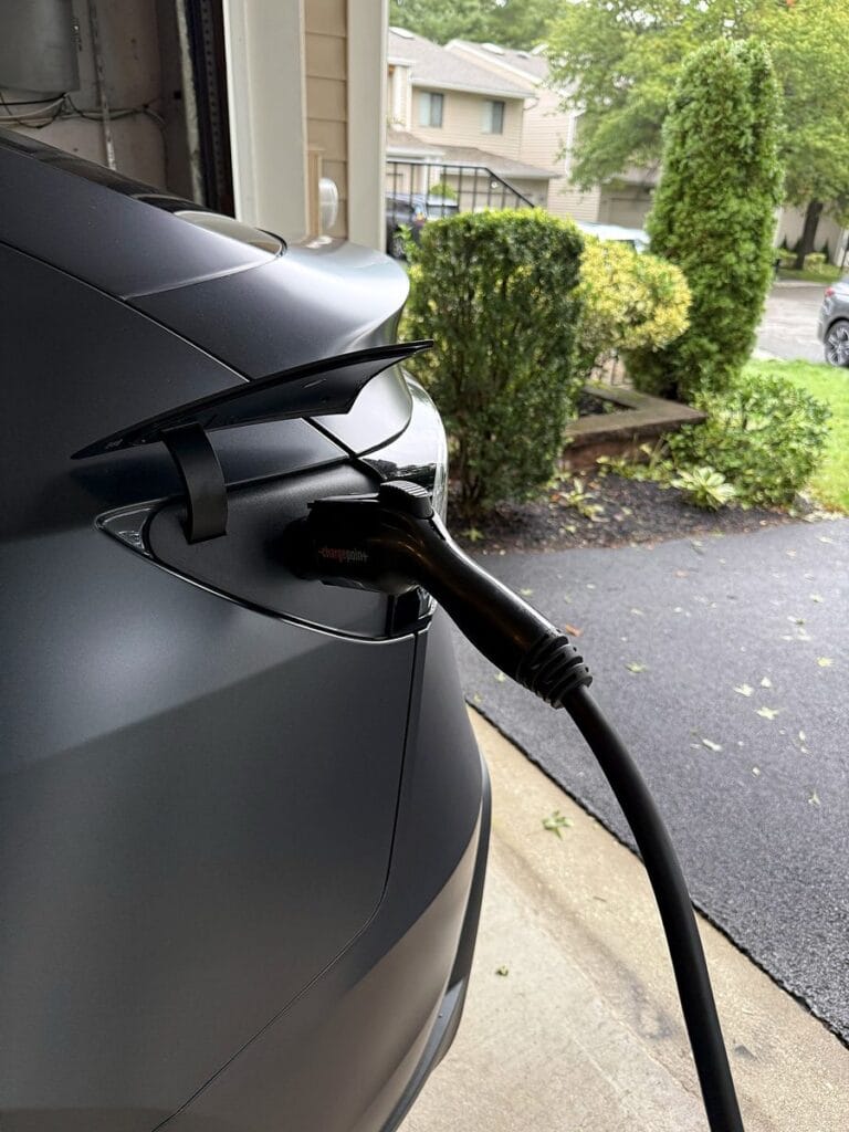 Tesla Model Y charging from a ChargePoint Home Flex at the open garage door