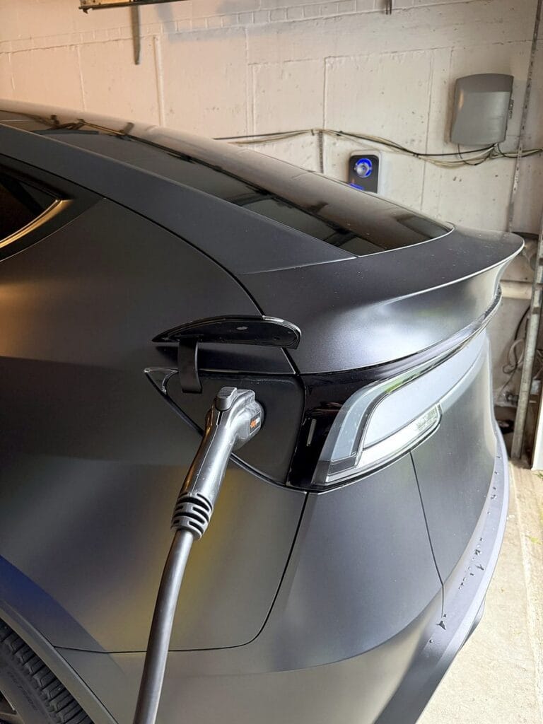Tesla Model Y charging in a garage from a wall-mounted ChargePoint Home Flex