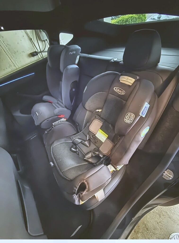 Graco 4Ever Extend2Fit in a Tesla Model Y viewed from the open rear door