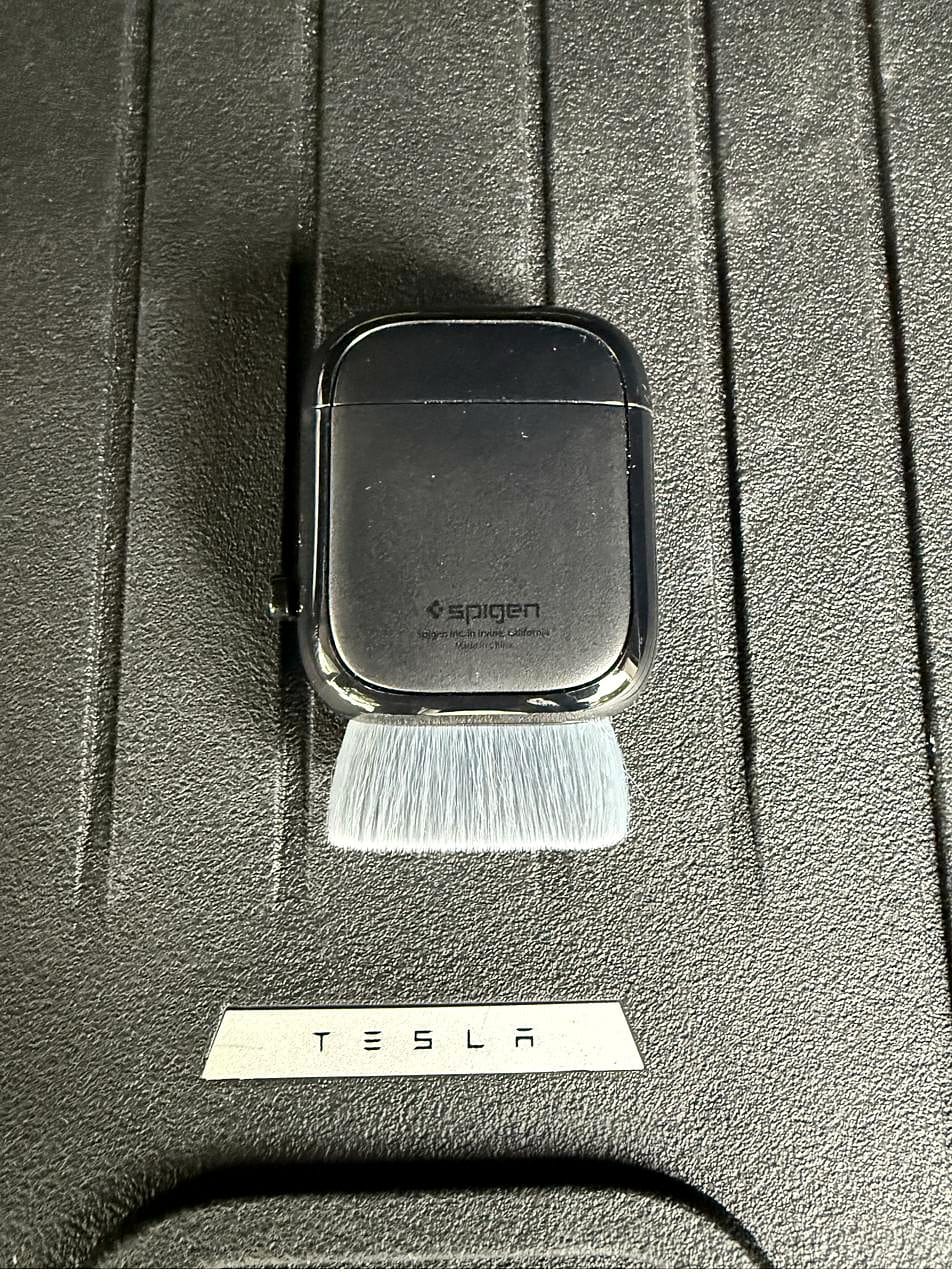 Spigen EZ Slide screen cleaner with the brush extended next to its case