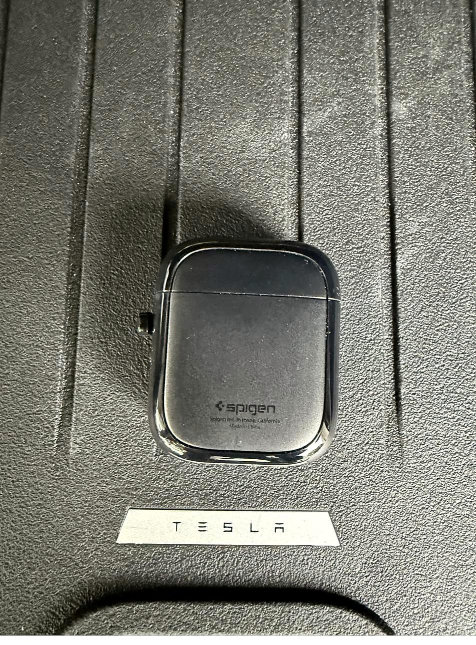 Spigen EZ Slide screen cleaner with its lid on, on a Tesla Model Y trunk mat