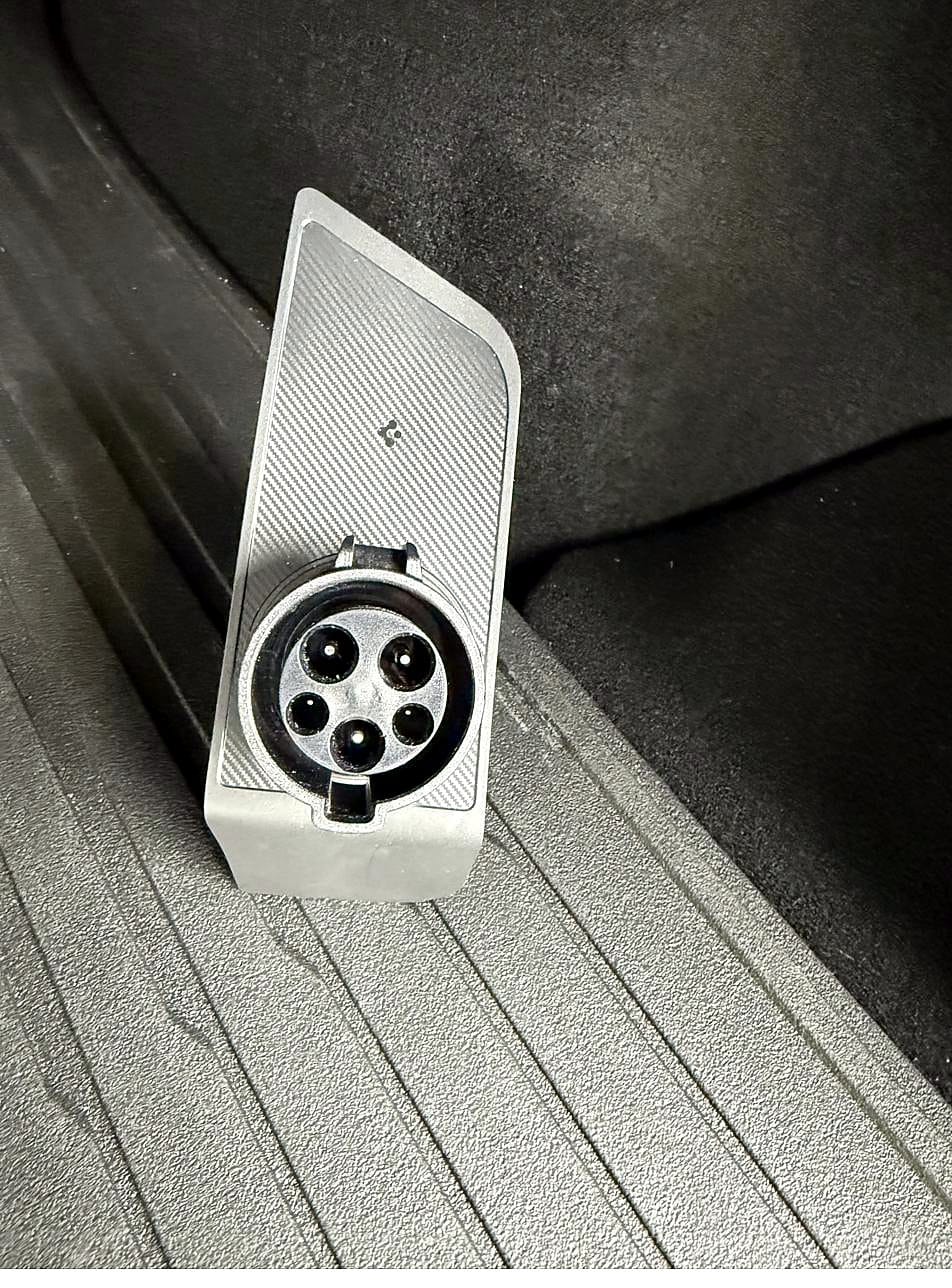 Tesla J1772 adapter docked in the Spigen holder
