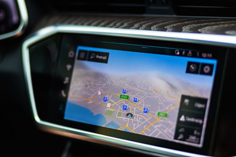 Close-up of a large car touchscreen displaying GPS navigation, similar to a Tesla center display