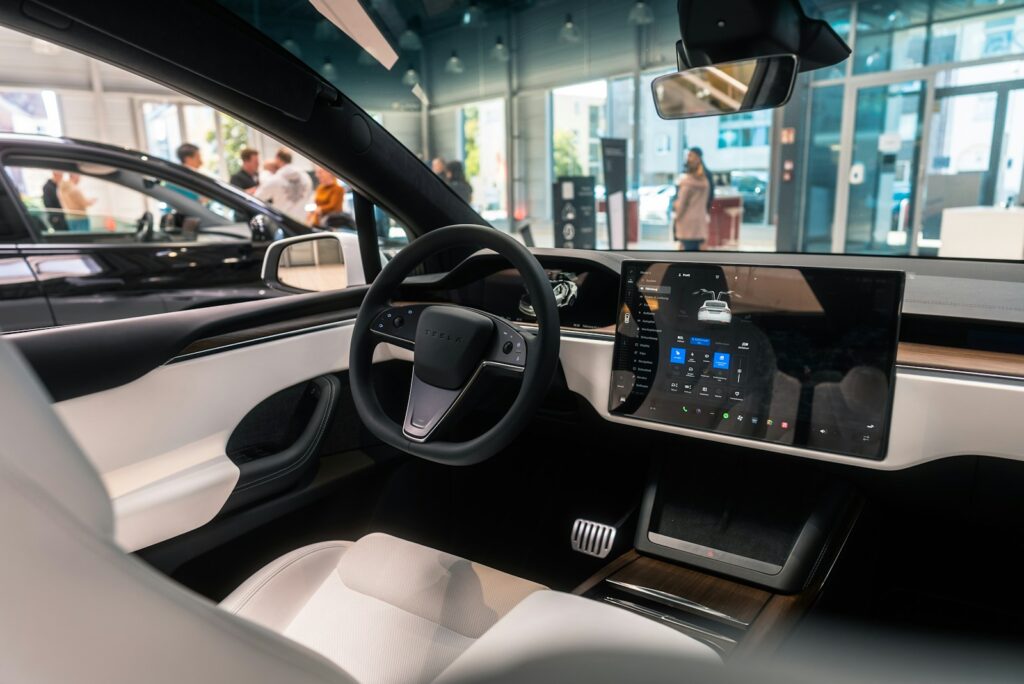 Sunlight streaming through a car's panoramic glass roof into the interior