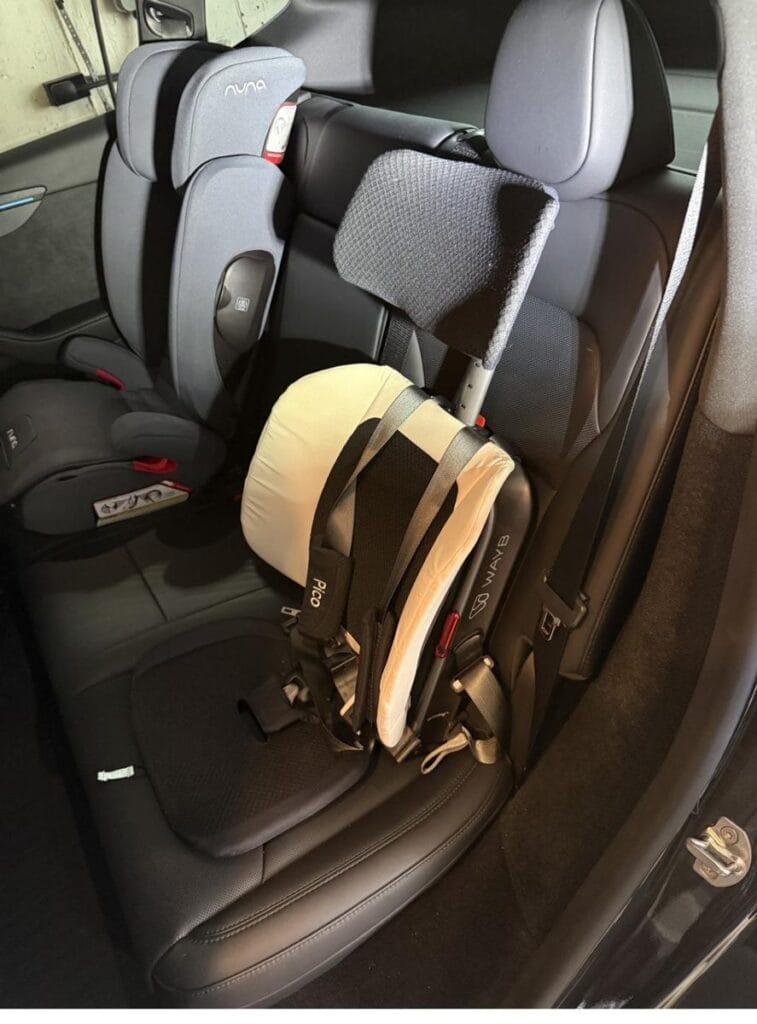 Side view of a WAYB Pico car seat installed in a Tesla Model Y