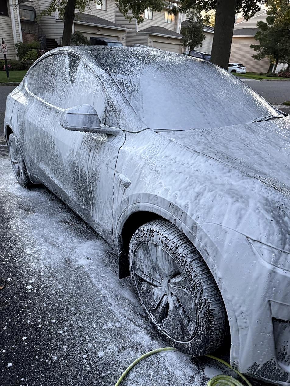 Tesla Model Y covered in foam during the pre-wash