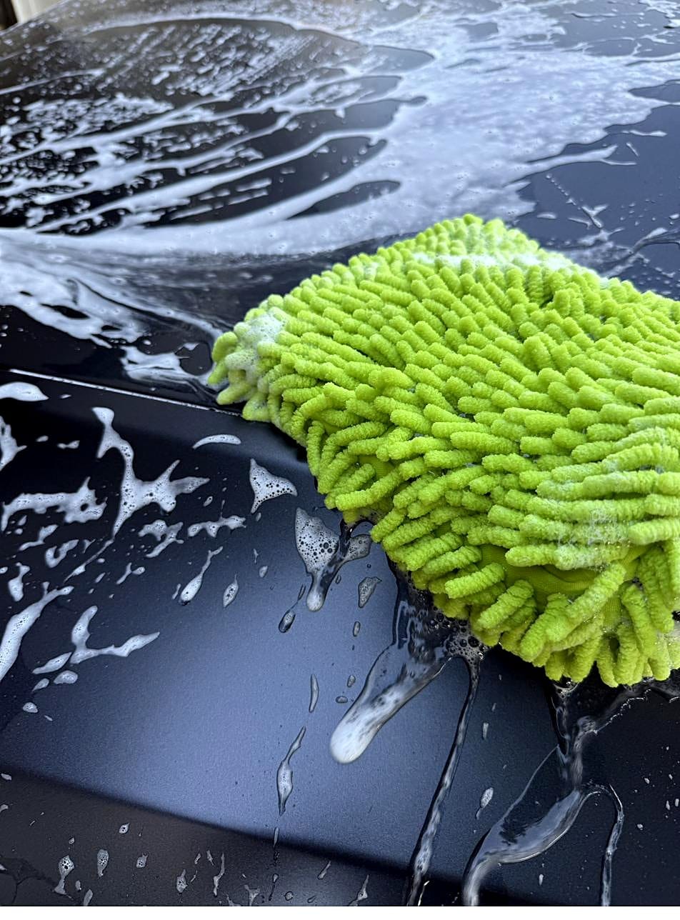Chenille wash mitt on a foamy Tesla Model Y hood