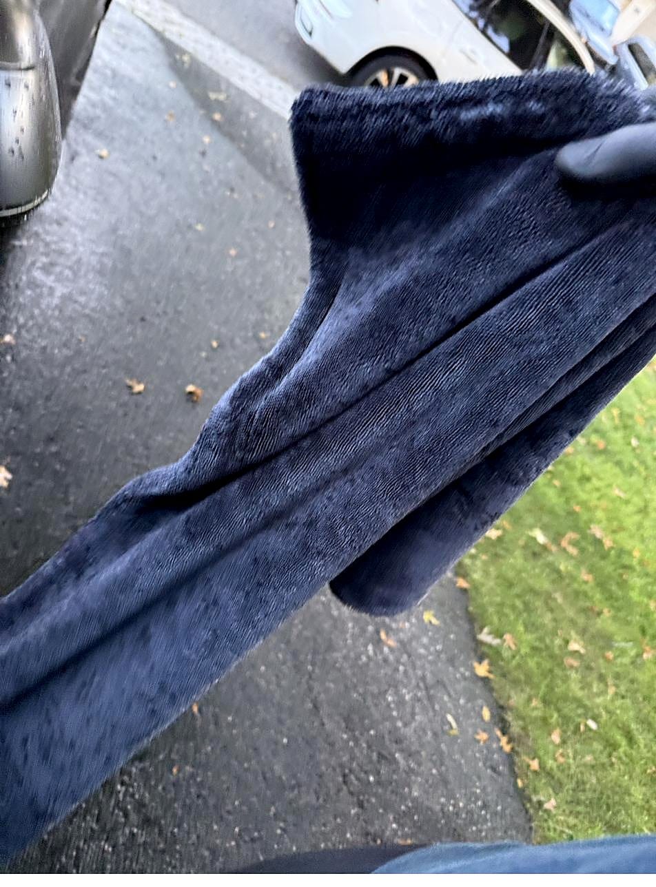Drying a Tesla Model Y with a plush navy towel